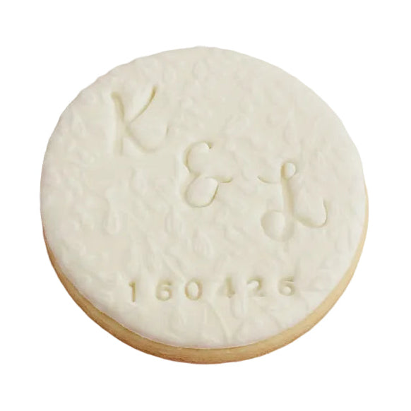 Personalised engagement round white signature vanilla sugar biscuit  embossed with a monogram design and the date.